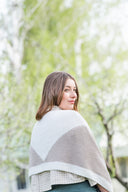 Woman wearing a three-color (white, green and blue) hand knit scarf